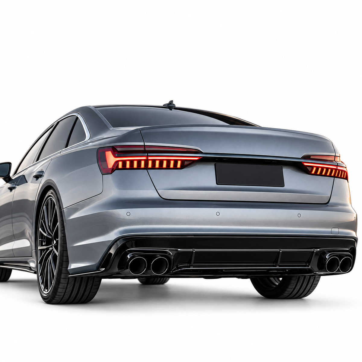 Audi A6 C8 met zwarte diffuser en vier uitlaatsierstukken op witte achtergrond